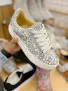 Put a little sparkle in your step with the REILY rhinestone sneakers. This sneaker can be paired with your best dress or favorite jean! Its intricate pattern is an eye-catching way to make a statement, no matter where you're wearing it. Manmade rhinestone platform sneakers Lace up closure Textile lining Rubber sole 1.5 inch platform Imported Luxury Party Sneakers With Glitter Accents, Rhinestone Shoes Sneakers, Casual Low-top Sneakers With Rhinestones, Trendy Low-top Rhinestone Sneakers, Casual Rhinestone Sneakers For Spring, Trendy Low-top Sneakers With Rhinestones, Trendy Rhinestone Low-top Sneakers, Party Sneakers With Bling And Lace-up Design, Party Sneakers With Bling And Lace-up