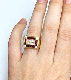 a woman's hand with a gold and diamond ring