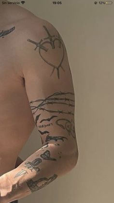 a man with tattoos on his arm and shoulder