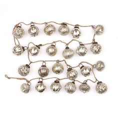 a bunch of silver ornaments hanging from a string