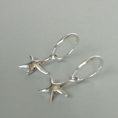 A PAIR of sterling silver hoops. Comes with a detachable tiny starfish charm. The charm is multipurpose and can be used with a neck or bracelet chain too. Dimension: Hoop- 12 x1.2 mm Charm- 11 mm Drop length- 22 mm These earrings are made of 925 hypoallergenic sterling silver. Please note this price is for ONE PAIR only. All my pieces are sent in a gift box. I can include a personal message from you if needed You are welcome to contact me at... bhavnakwintra1956@gmail.com For more beautiful piec Hoops Silver, Evil Eye Earrings, Thread Earrings, Bracelet Chain, Bohemian Earrings, Threader Earrings, Sterling Silver Hoops, 925 Jewelry, Star Charms