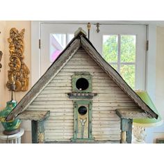 a white birdhouse sitting on top of a table