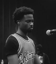 a man standing in front of a microphone