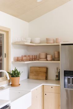 the kitchen is clean and ready to be used for cooking or baking, with dishes on the shelves