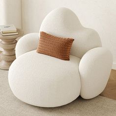 a white chair with a brown pillow on it