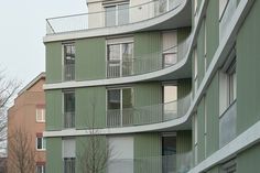 an apartment building with balconies on the second floor