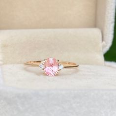 This elegant sapphire Ring featuring a 0.85ct Unheated & Untreated Natural Peach champagne Sapphire with two natural white diamonds Set in 14K solid Rose Gold, handcrafted in Sri Lanka.Main Stone : Natural Peach SapphireShape: OvalWeight: 0.85caratColor: Champagne PeachTreatment: NoneClarity : VSOrigin: Sri Lanka (Ceylon)Accent Stones: Natural White Diamonds (1.8mm)Metal: 14K Rose Gold (Available in Yellow Gold & White Gold, 18k Gold, Please get in touch with me ) Peach Champagne Sapphire, Champagne Sapphire, Peach Sapphire, Pink Sapphire Ring, Sapphire Diamond Ring, Sapphire Diamond, White Diamonds, Pink Sapphire, Diamond White