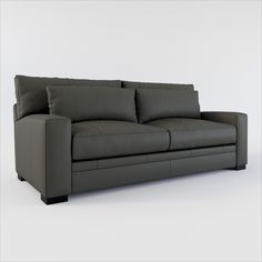 a black leather couch with pillows on it's back and arm rests against a white wall