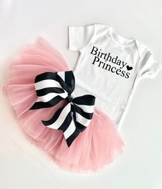 This full tutu has ten layers with a wide elastic band inside to keep the itchy tulle off your little ones' skin. The multiple soft layers give a fluffy look but lays perfectly. The bow can clip onto the tutu for your desired look. OPTIONS AVAILABLE FOR PURCHASE: Bodysuit/ Shirt Tutu with removable bow Crown Tutus are perfect for birthdays, weddings, holidays, and every day! Our tutus are super stretchy and can grow with your child. Please message me if you have any questions about sizing or col Black Princess Style Tutu Dress For Birthday, Cute Fitted Tutu Dress For Birthday, Fitted Birthday Tutu Dress With Tulle Skirt, Fitted Tutu Dress With Tulle Skirt For Birthdays, Fitted Tulle Tutu Dress For Birthday, Fitted Tutu Dress With Tulle Skirt For Birthday, Black Tulle Tutu Dress For Birthday, Princess Style Fitted Tutu Dress For Birthday, White Fitted Tutu Dress For Birthday