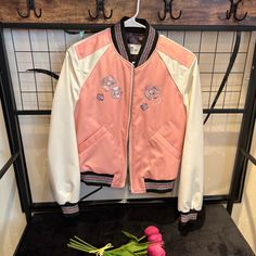 100% Authentic Coach Floral Embroidered Cropped Baseball Jacket Shell: 100% Polyester Lining: 100% Polyester Filling: 100% Polyester Zip Closure, Slip Pockets, Water-Resistant Spring Varsity Jacket With Embroidered Graphics, Trendy Pink Embroidered Outerwear, Spring Outerwear With Embroidered Logo And Long Sleeves, White Embroidered Varsity Jacket For Spring, Spring Long Sleeve Outerwear With Embroidered Logo, Spring Outerwear With Embroidered Patch, Spring Varsity Jacket With Embroidered Patch And Long Sleeve, Spring Embroidered Varsity Jacket With Long Sleeves, Embroidered Long Sleeve Varsity Jacket For Spring