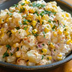 a bowl filled with corn salad on top of a wooden table