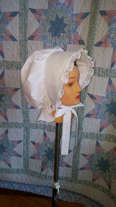 This pretty bonnet is suitable for most Historical events. Our poke bonnet features eyelet lace around the brim and an adjustable back so that it will fit most head sizes. The brim is filled and quilted with a felt insert, so that it will stay stiff and not droop in the rain. The back of the bonnet has a curtain to protect the neck from sunburn. The bonnet is made from 100% white cotton muslin so can be machine washed and bleached if necessary. Properly taken care of, this item should provide yo Pioneer Wagon, Prairie Bonnet, Poke Bonnet, Girls Costumes, Womens Aprons, Living History, Eyelet Lace, Historical Events, Muslin Cotton