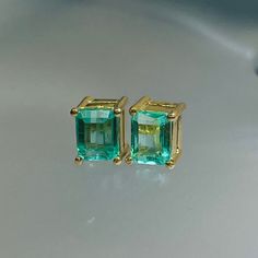 Featuring natural and earth mined emeralds. They are set in solid 18K yellow gold basket settings. The emeralds have a medium green hue with a bright luster and excellent clarity  6.5x4mm Marked 18K and sold with 18K backs Luxury Green Emerald-cut Earrings, Yellow Gold Tsavorite Earrings As Gift, Tsavorite Yellow Gold Earrings For Gift, Emerald Cut Green Gemstone Earrings, Emerald Cut Green Earrings, Green Emerald Earrings With Prong Setting, Emerald Green Earrings For Anniversary, Gold Emerald-cut Emerald Earrings, Gold Emerald Cut Emerald Earrings