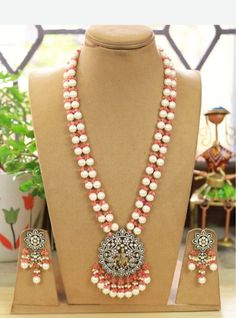 Temple Jewelry necklace of Pearl and Beads with matching earrings Perfect for any kind of occasions and ceremonies. You can wear it with Saree lehenga and Evening Gowns. Highest quality and craftsmanship. Arrives in box Please let me know if you have any questions White Temple Jewelry Beaded Necklaces For Wedding, Handmade White Temple Jewelry Bridal Necklace, White Temple Jewelry Beaded Necklace For Wedding, Handmade White Bridal Temple Jewelry Necklace, Temple Jewelry Style Pearl Pendant Necklace For Wedding, Temple Jewelry Pearl Pendant Necklace For Wedding, White Temple Jewelry Necklace With Pearl Drop, White Long Pearl Necklace For Festive Occasions, White Temple Jewelry Bridal Necklace For Celebration