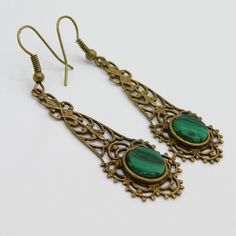 Long filigree earrings are a soft aged brass and have a green black glass stone at the bottom. These are so pretty and lightweight. The contrast of the brass and green is really nice. The earwires were missing so I did replace them. They are unmarked and in excellent condition. The drops alone measure 1 3/4 inch and from the top of the earwire to the bottom of the drop they are 2 1/4 inch. The kind of earring you find yourself reaching for all the time. Cute, dangly and comfortable. Find lots mo Vintage Green Brass Earrings, Pierced Green Copper Earrings, Green Copper Pierced Earrings, Green Brass Earrings, Green Brass Earrings As Gift, Green Brass Earrings For Gift, Elegant Green Copper Earrings, Victorian Green Dangle Earrings, Victorian Green Drop Earrings