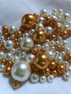 a pile of white and gold pearls