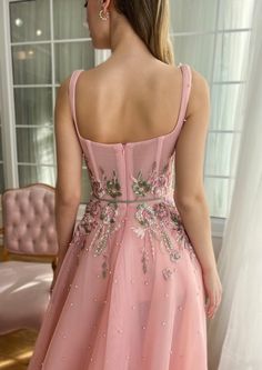 the back of a woman's dress in pink