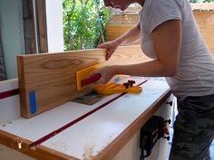 a woman measuring the width of a piece of wood