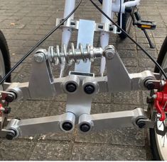 the front wheel of a bicycle with four spokes and red brake pads on it