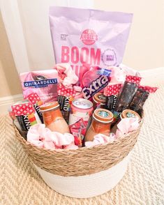 a basket filled with lots of different types of food and snacks on top of a carpeted floor