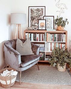 a living room filled with furniture and bookshelves next to a wall covered in pictures