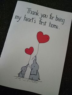 a card with an elephant holding two red hearts and the words thank you for being my heart's first home