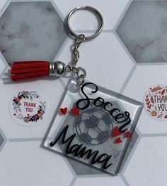 a keychain with a soccer ball on it that says, thank you mama