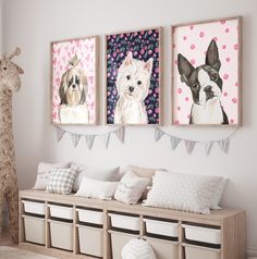 three dogs are hanging on the wall next to some storage bins with pillows and stuffed animals