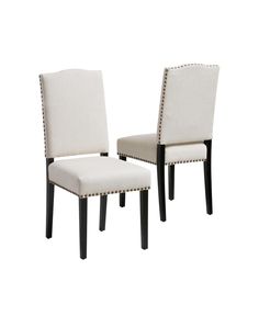 a pair of white chairs sitting next to each other