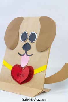 a paper bag with a dog holding a heart on it's chest and eyes