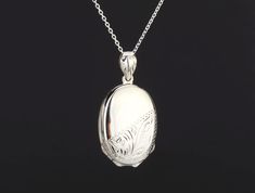 "Custom engraved oval four photo locket,custom engraving,personalized memorial locket,mother's day gift,remembrance jewelry,anniversary locket with photos Perfect as a Mother's Day gift, this custom engraved four photo locket necklace has: 1. One shining, highly polished sterling silver locket (26 x 19mm, 11.5 grams). It is also a bit heavy with 4 locket leaves inside.     It can be engraved on the front and back (use pulldown menu to select)     The front has its bottom half etched with a flora White Gold Oval Pendant Locket Necklace, White Gold Sterling Silver Oval Pendant Locket Necklace, Oval White Gold Sterling Silver Locket Necklace, Formal White Gold Oval Pendant Locket Necklace, Personalized Oval Locket Necklace Elegant Style, Classic Sterling Silver Oval Locket Necklace, Silver Oval Locket Necklace For Wedding, White Oval Pendant Locket Necklace, Classic Memorial Locket Necklace With Polished Finish