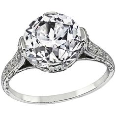 a white gold ring with an oval cut diamond in the center