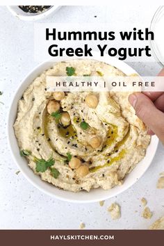 hummus with greek yogurt in a white bowl on top of a table