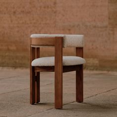 a wooden chair sitting on top of a stone floor