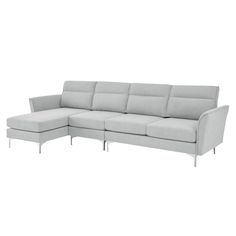 a white sectional couch sitting on top of a white floor next to a chair and ottoman