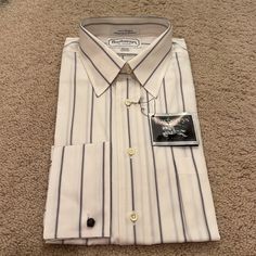 Vintage Burberry Dress Shirt. New With Tags. Size Is 15.5 (32-33). 100% Cotton. Shirt Is Pinned In Original Packaging, So I’ve Opted Not To Take It Off To Photograph. However, Let Me Know If You Need Additional Information And I’d Be Happy To Help. Elegant Striped Button-up Dress Shirt, White Semi-formal Spring Shirt, Elegant Striped Dress Shirt With Spread Collar, Elegant Striped Collared Shirt, Elegant Short Sleeve Dress Shirt For Spring, Classic Spring Dress Shirt For Daywear, Elegant Striped Shirt, White Formal Shirt For Spring, White Dress Shirt For Spring Business Casual