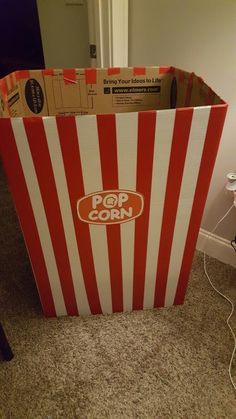 a red and white striped box sitting on the floor