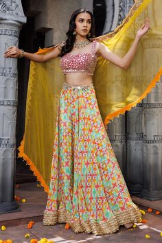 Pink, yellow, multicolor lehenga with geometric print all over and embroidered border. Paired with mirror, pearl, beads, dori embroidered padded blouse and dupatta.
Components: 3
Pattern: Printed, Embroidery
Type Of Work: Geometric, mirror, pearl, bead, dori
Neckline: Sweetheart neck
Sleeve Type: Sleeveless
Fabric: Crepe
Color: Multi Color
Other Details: 
Lehenga:
Geometric pattern
Embroidered border
Approx. product weight: Less than 2 kgs
Blouse:
Padded
Pearl drops on hem
Dupatta:
Cutwork embro Yellow Georgette Sets With Printed Motifs, Designer Multicolor Lehenga With Mirror Work, Multicolor Palazzo Set With Mirror Work For Reception, Bollywood Style Multicolor Mirror Work Set, Multicolor Zari Work Palazzo Set For Reception, Multicolor Georgette Sets For Navratri, Designer Multicolor Choli With Mirror Work, Multicolor Palazzo Set With Zari Work For Reception, Fitted Multicolor Anarkali Set For Summer