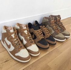 four pairs of sneakers are lined up on the floor