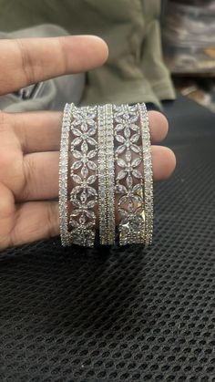 Ashura jewels beautiful wedding wear diamond bangle set this is a 6 pcs Kada bracelet silver polished bangle set this set is very easy to wear. we ship our items everywhere. Colour white design bangle stone Pearl beads  2.4,2.6,2.10,2.12 Size available These openable bangles can be wear by 2.8 size person.   material gold plated Standard shipping takes 3 to 4 weeks to deliver the parcel if a customer needs an item urgently then we can ship the item through Express shipping it takes 3 to 6 days t Dazzling Diamond Cut Bracelets For Party, Diamond Sparkling Bangle For Anniversary, Party Silver Diamond Cut Bracelet, Dazzling Bangle Bracelets For Anniversary, Dazzling Bangle Bracelet For Anniversary, Round Diamond Cut Bracelet For Party, Dazzling Elegant Bracelets As Gift, Party Hand Set Diamond White Bracelet, Diamond White Bangle For Party