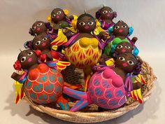 a basket filled with lots of colorfully decorated eggs