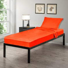 an orange bed is in the middle of a room