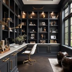 a home office with black cabinets and gold accents