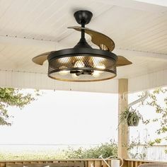 an outdoor ceiling fan is hanging from the ceiling over a table and chairs on a porch