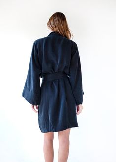 The vegan silk kimono that we already know and love, now with an exciting twist. It's time to show a little leg in our new Mini. Sustainably made using our washable vegan silk, this classic fit features a wrap front silhouette with a matching detachable sash, and voluminous wide sleeves - designed and cut to beautifully fit all sizes. This is the closet-staple mini dress that every wardrobe needs. Enjoy it in the comfort of your home, by the pool over your favorite bikini, or dressed up for any Silk Fitted Robe For Loungewear, Fitted Silk Robe For Loungewear, Silk Wrap Kimono For Daywear, Silk Wrap Robe With Tie Waist, Fitted Silk Robe For Daywear, Silk Wrap Kimono For Loungewear, Chic Silk Wrap Robe, Fitted Wrap Robe, Silk Tie Waist Kimono For Loungewear