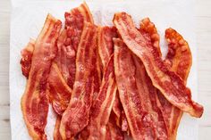 bacon strips sitting on top of a white napkin