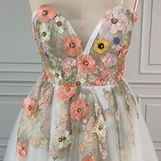 a white dress with pink flowers on it