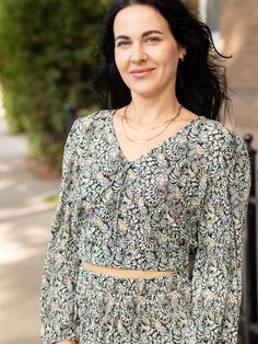 Boho inspired, this look from Z Supply is sure to make a style statement. A super cropped bodice features long, billowed sleeves. An overall textured crinkle like appearance pairs perfectly with the boho inspired floral print throughout. Fabric covered buttons line the center down from a v-neckline. Mix and matching this top with the coordinating bottoms for a fun two piece look we love. Z Supply Crinkle textured fabrication Long, billowed sleeves Fabric covered buttons Ultra cropped Can be pair Cropped Top With Gathered Sleeves For Fall, Chic Long Sleeve Crop Top With Blouson Sleeves, Fall Cropped Top With Blouson Sleeves, Spring Long Sleeve Crop Top With Elastic Sleeves, Chic Blouson Sleeves Crop Top, Elegant Long Sleeve Crop Top With Blouson Sleeves, Cropped Blouse With Gathered Sleeves For Fall, Chic Crop Top With Blouson Sleeves, Chic Crop Top With Blouson Sleeves For Fall