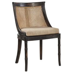 a wooden chair with caned back and beige upholstered seat, on an isolated white background