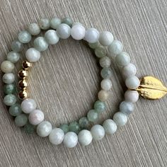 A beautifully beaded Aquamarine and Aventurine elastic bracelet stack with gold filled beads. The gold leaf charm is brass. The gold leaf can be removed and replaced with a metal stamped charm (see pictures for reference), or completly removed with no charm. Gold Amazonite Beaded Bracelets, Gold Aventurine Round Bead Bracelets, Gold Aventurine Beaded Bracelets, Handmade Gold Aventurine Beaded Bracelets, Adjustable Gold Aventurine Beaded Bracelets, Gold Beaded Aventurine Bracelets With Natural Stones, Gold Beaded Bracelets With Natural Aventurine Stones, Gold Beaded Bracelets With Aventurine Stones, Gold Beaded Bracelets With Amazonite Round Beads